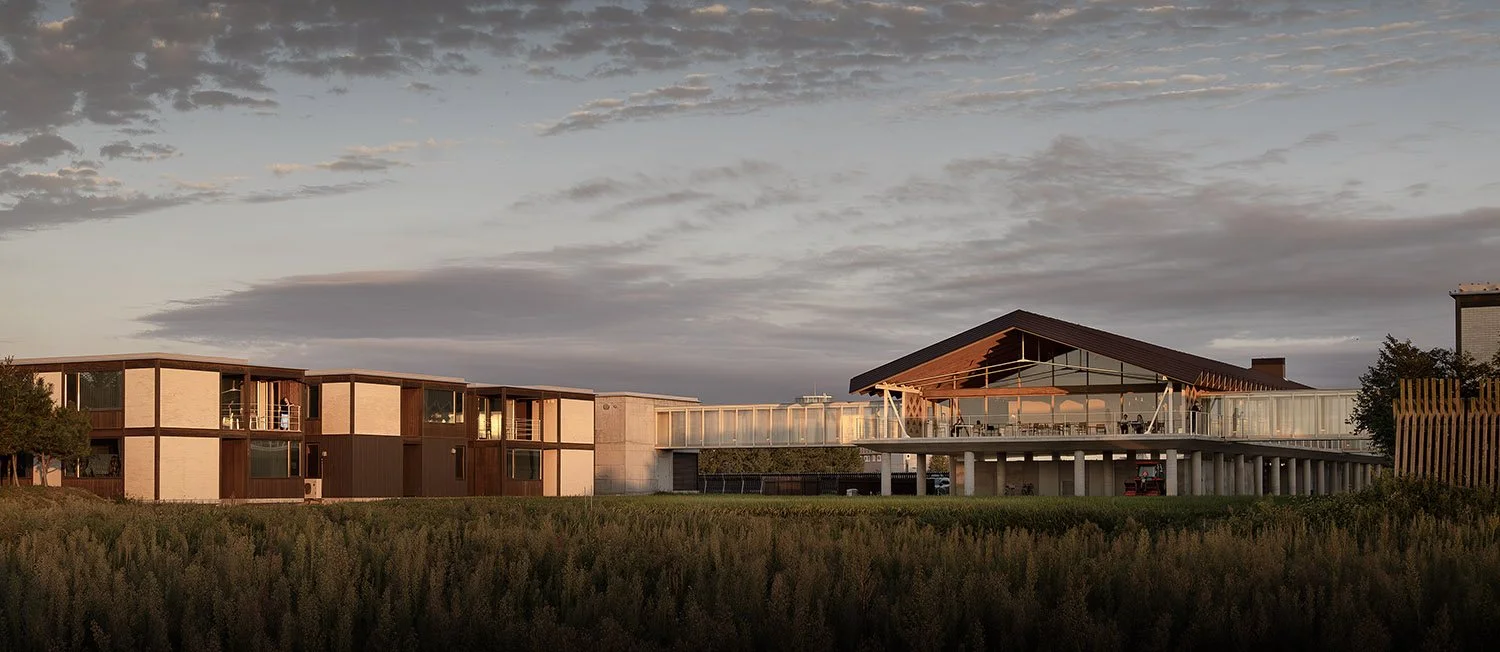 Hotel buildings and timber pavilion at dusk — Suiden Terrace