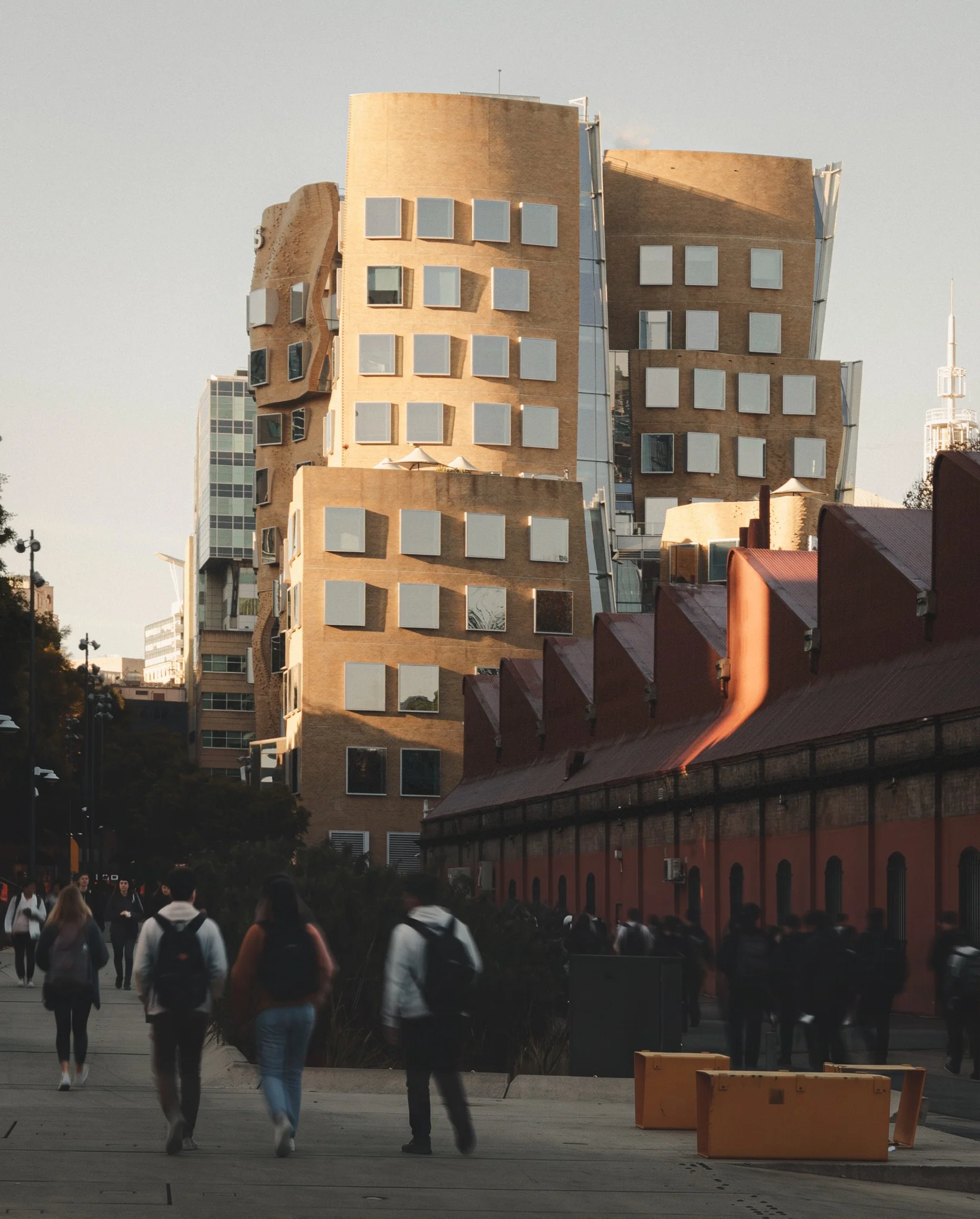Sculptural brick university building above a pedestrian walkway — UTS Dr Chau Chak Wing Building